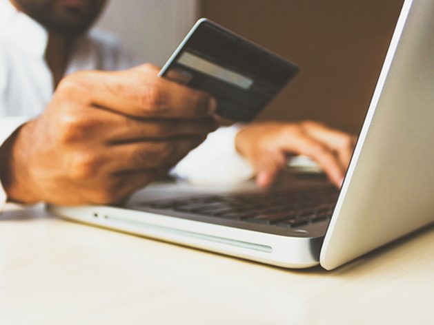 Photo of a credit card and laptop